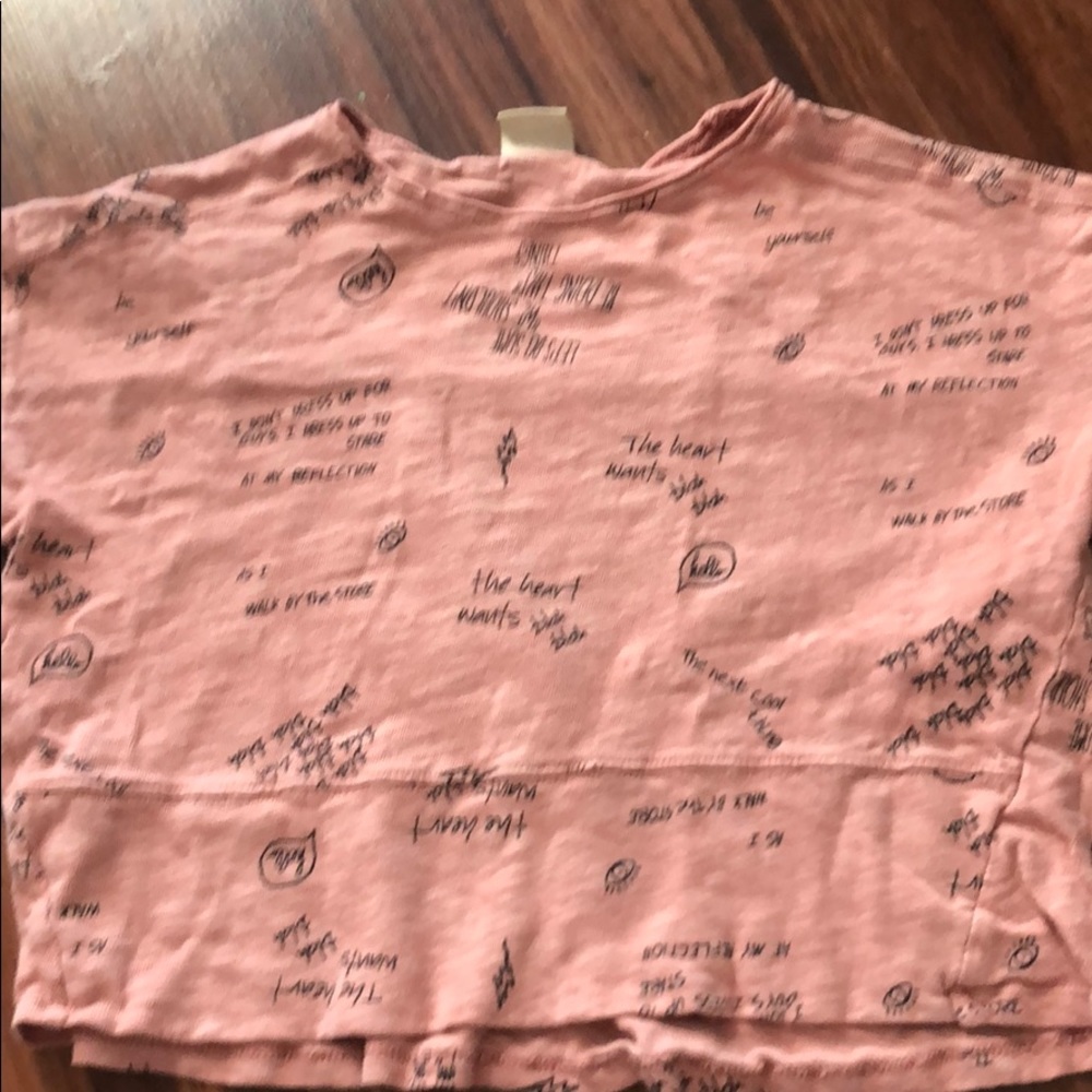 Pink shirt with black text